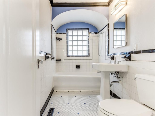 bathroom with tile walls, sink, tile patterned flooring, and toilet