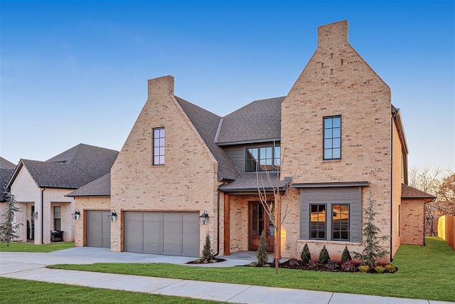 view of front of house with a front yard and a garage