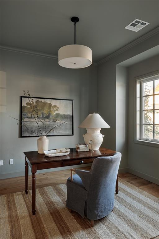 home office featuring ornamental molding and light wood-type flooring