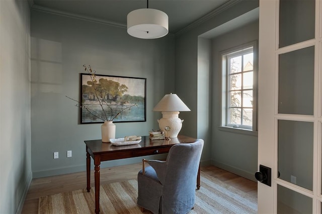 office area with crown molding and light hardwood / wood-style flooring