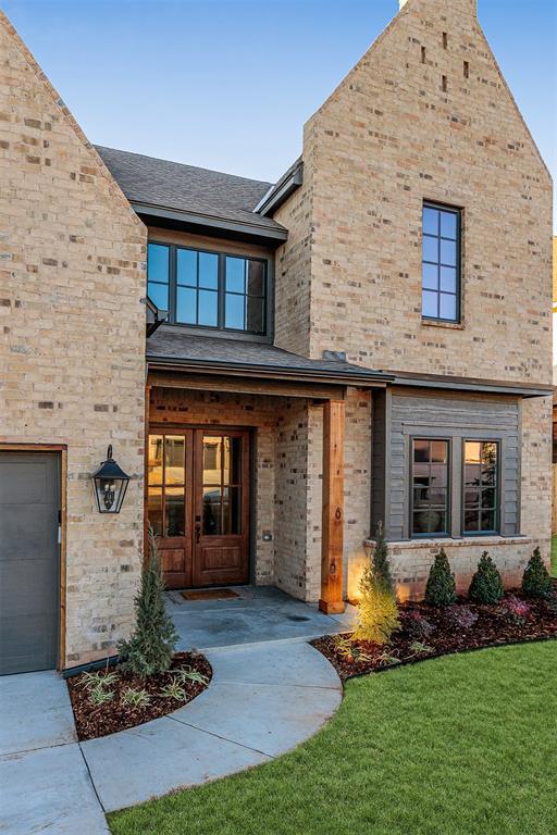 doorway to property featuring a yard, a garage, and french doors