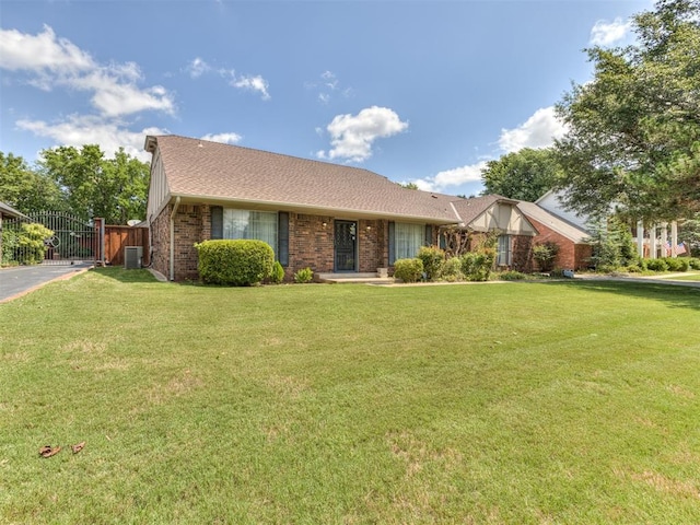 single story home with central air condition unit and a front yard