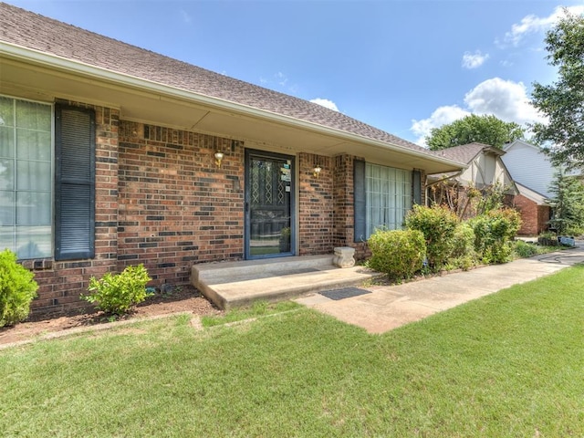 doorway to property with a yard