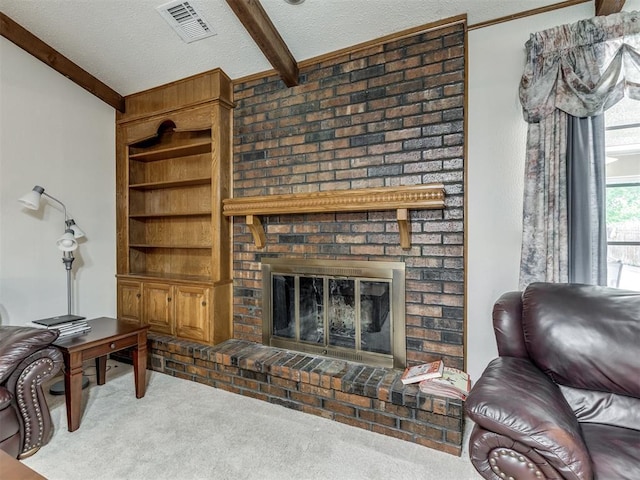 carpeted living room with beam ceiling, a fireplace, and a textured ceiling