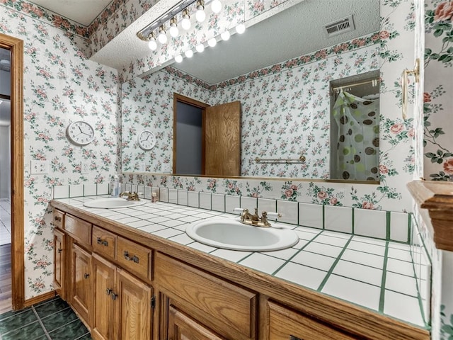 bathroom with vanity, tile patterned floors, and walk in shower