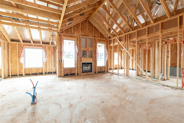 miscellaneous room with lofted ceiling and a fireplace