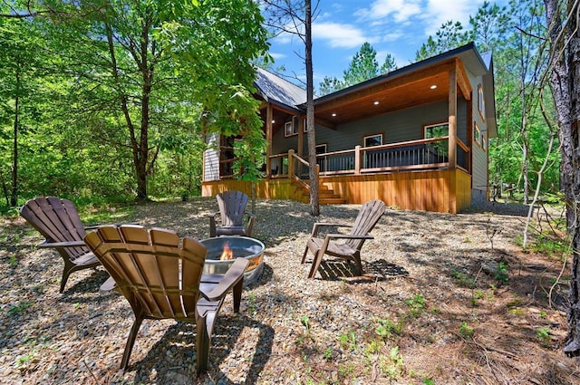 back of house with an outdoor fire pit