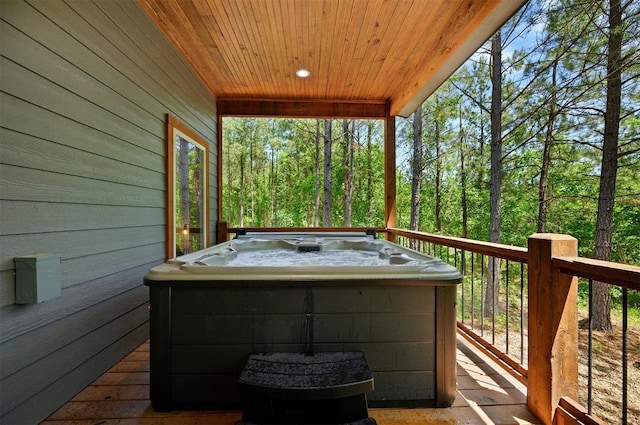 wooden terrace featuring a hot tub