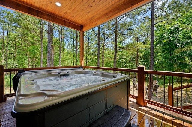 wooden deck with a hot tub