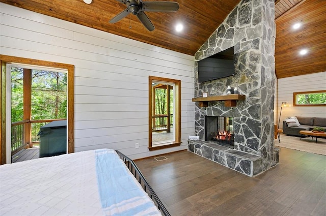 bedroom featuring dark wood-type flooring, wood walls, high vaulted ceiling, ceiling fan, and wooden ceiling