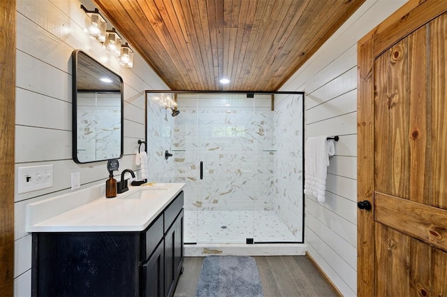 bathroom with hardwood / wood-style floors, wood walls, a shower with door, vanity, and wood ceiling