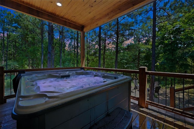 wooden deck with a hot tub