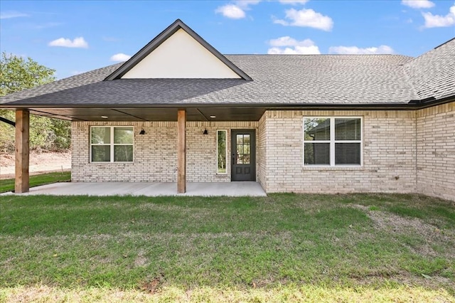 back of house featuring a lawn and a patio