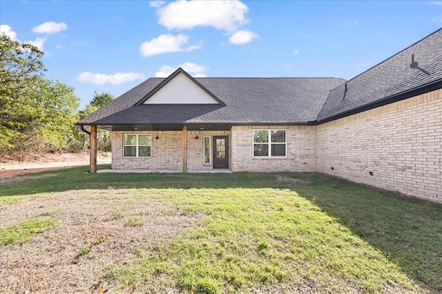 rear view of house with a lawn