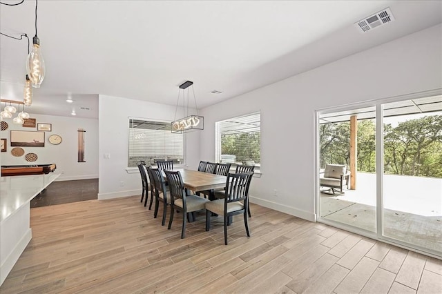 dining space featuring light hardwood / wood-style floors, plenty of natural light, and pool table