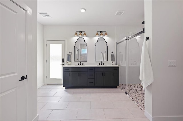 bathroom featuring tile patterned floors, vanity, and a shower with shower door