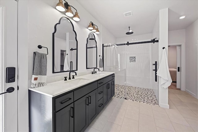 bathroom with tile patterned floors, vanity, and walk in shower