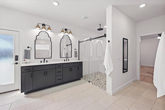 bathroom featuring a shower, tile patterned flooring, vanity, and ceiling fan