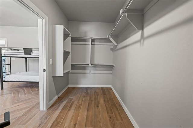 spacious closet with hardwood / wood-style flooring