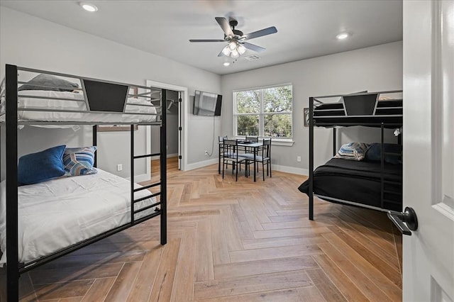 bedroom featuring ceiling fan and parquet flooring