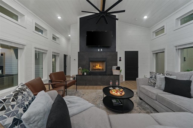 living room with hardwood / wood-style floors, wooden ceiling, a fireplace, and high vaulted ceiling