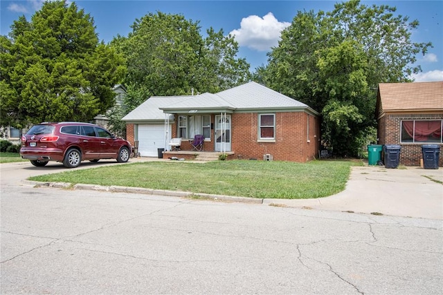 view of front of property with a garage and a front lawn