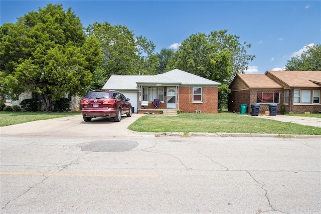 view of front of property featuring a garage and a front lawn