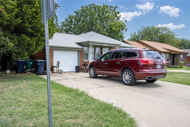 view of front of house with a front lawn and a garage