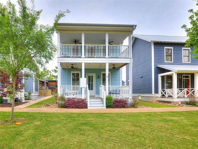 view of front of house featuring a porch, a balcony, and a front yard