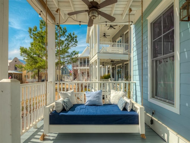 exterior space featuring ceiling fan and a balcony