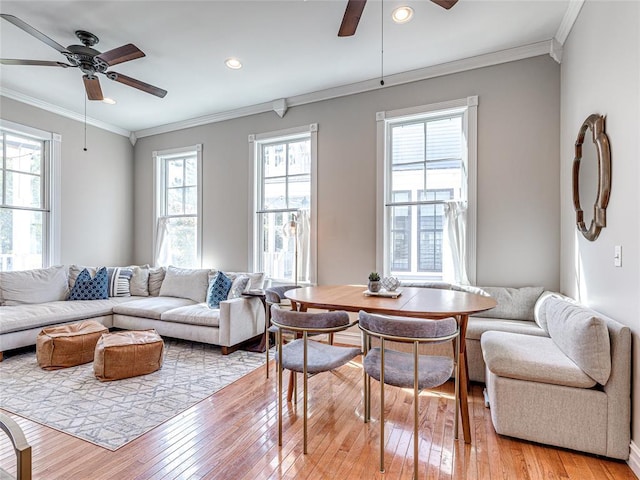 living area with light wood-style floors, recessed lighting, ornamental molding, and a ceiling fan