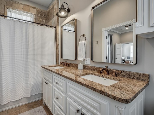 bathroom featuring double vanity, a healthy amount of sunlight, shower / bath combo with shower curtain, and a sink