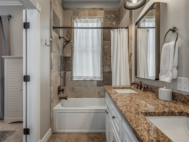 bathroom featuring double vanity, a healthy amount of sunlight, shower / bath combo with shower curtain, and a sink