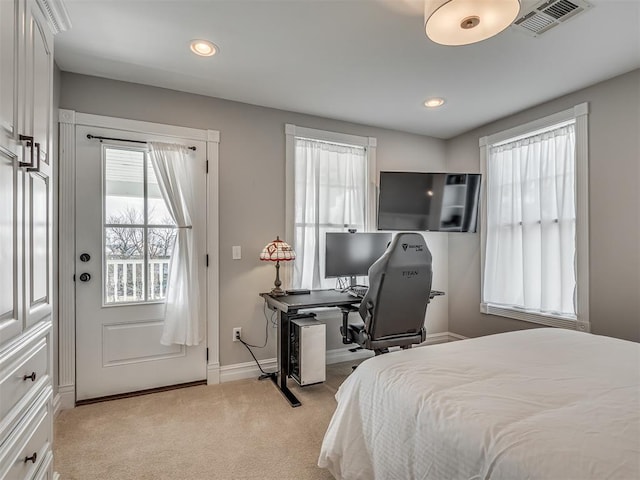 bedroom with light colored carpet, visible vents, baseboards, and multiple windows