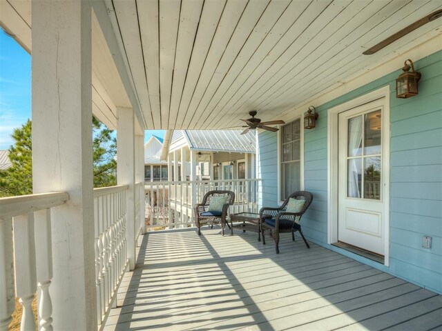 deck with ceiling fan and covered porch