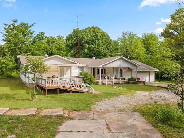 single story home with a front yard, a porch, and a garage