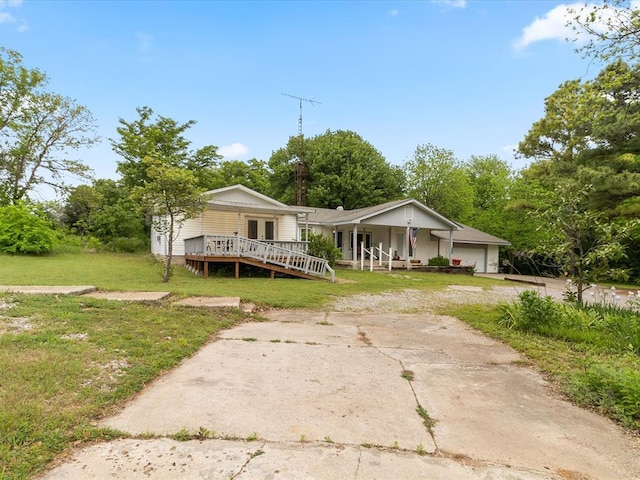 bungalow-style house featuring a garage, a porch, and a front yard