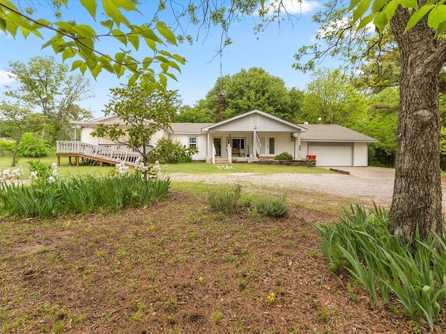 single story home with a porch and a garage