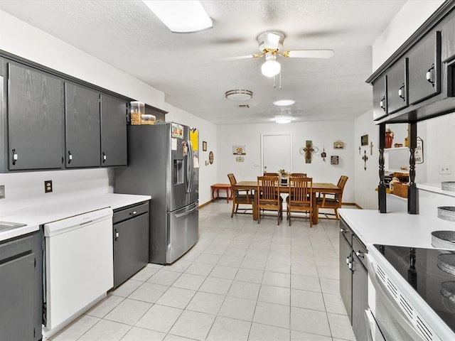 kitchen with ceiling fan, white appliances, a textured ceiling, and light tile patterned floors