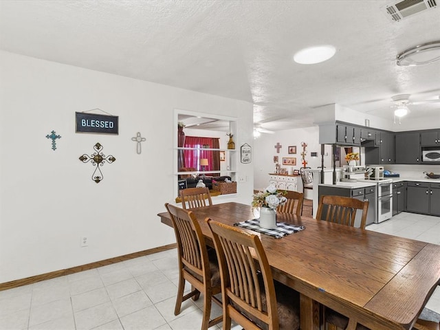 tiled dining room featuring ceiling fan