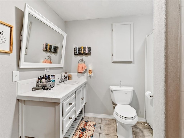 bathroom featuring tile patterned flooring, vanity, and toilet