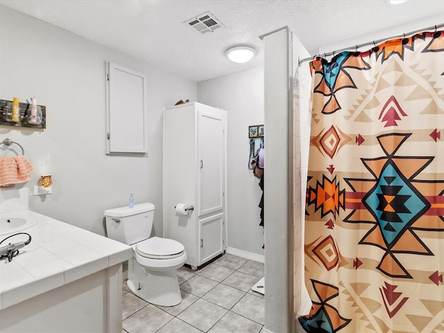 bathroom featuring a textured ceiling, vanity, tile patterned flooring, toilet, and curtained shower