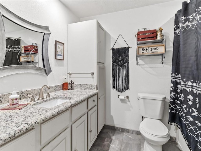 bathroom featuring tile patterned flooring, vanity, and toilet