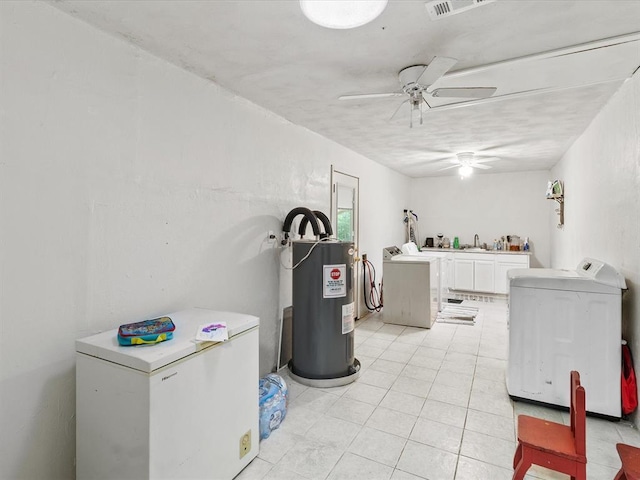 laundry area featuring ceiling fan, sink, water heater, light tile patterned floors, and washing machine and clothes dryer