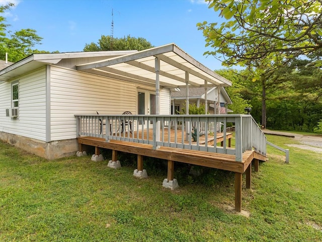 rear view of house with a yard, a deck, and cooling unit