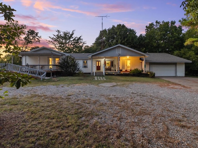 ranch-style house with a porch and a garage