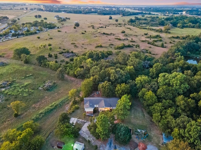 aerial view at dusk featuring a rural view