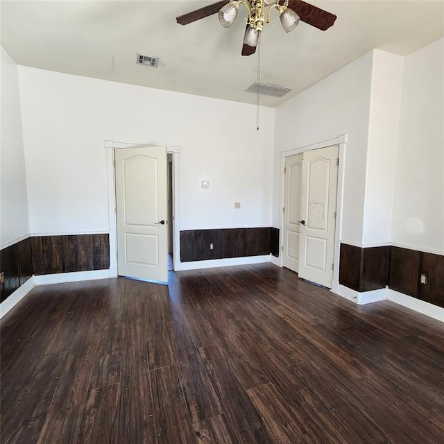 spare room with ceiling fan and dark hardwood / wood-style flooring