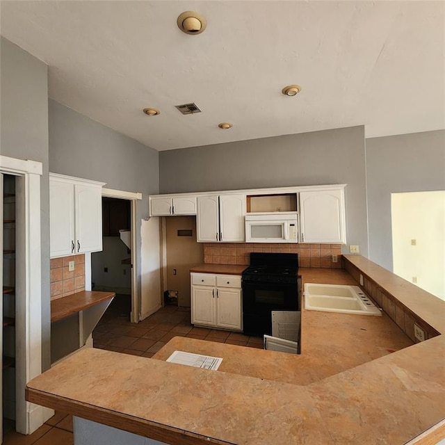 kitchen featuring sink, white cabinets, and black range with electric cooktop