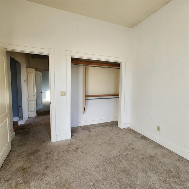 unfurnished bedroom with a closet and carpet